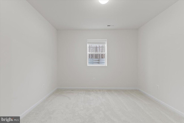 unfurnished room featuring light carpet