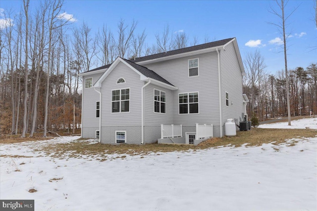 snow covered house with central AC