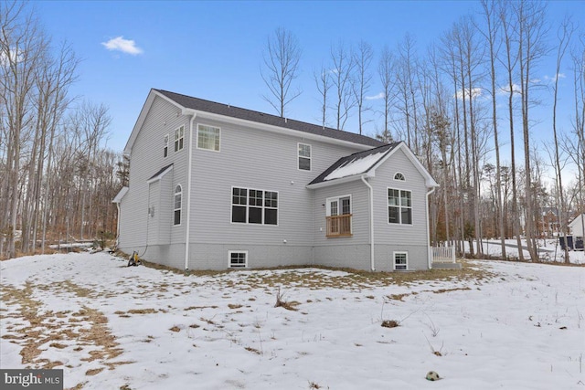 view of snow covered rear of property