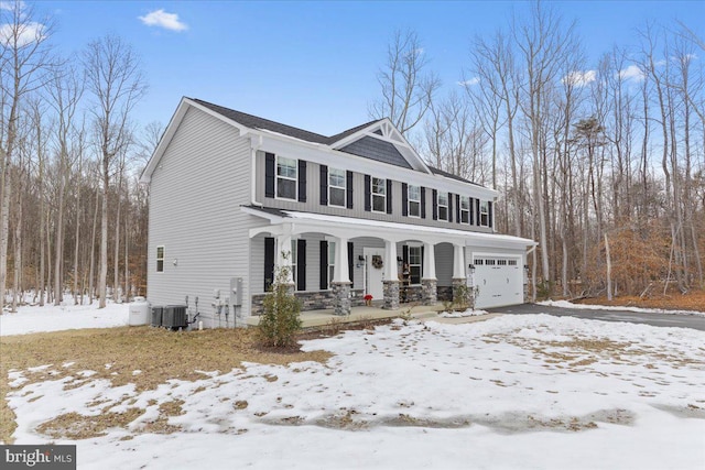 view of front of house with covered porch, cooling unit, and a garage