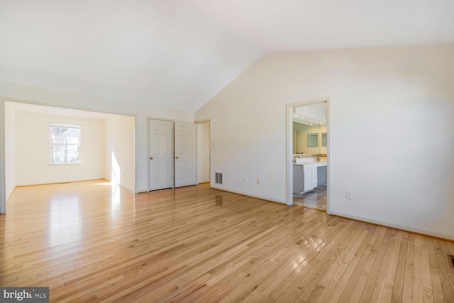 interior space with vaulted ceiling and light hardwood / wood-style floors