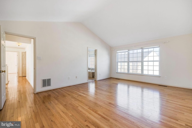 unfurnished living room featuring high vaulted ceiling and light wood-type flooring