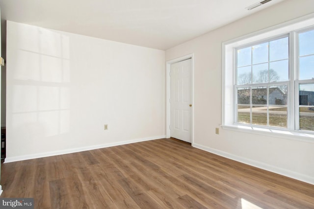 empty room featuring wood-type flooring