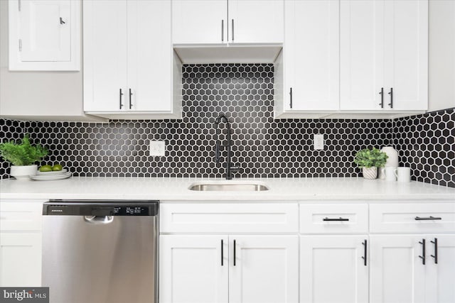 kitchen with white cabinetry, decorative backsplash, and dishwasher