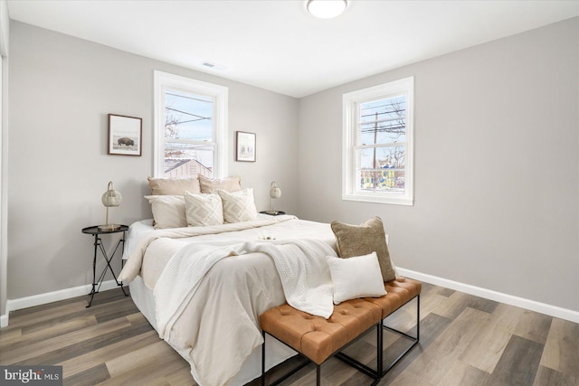 bedroom with hardwood / wood-style flooring