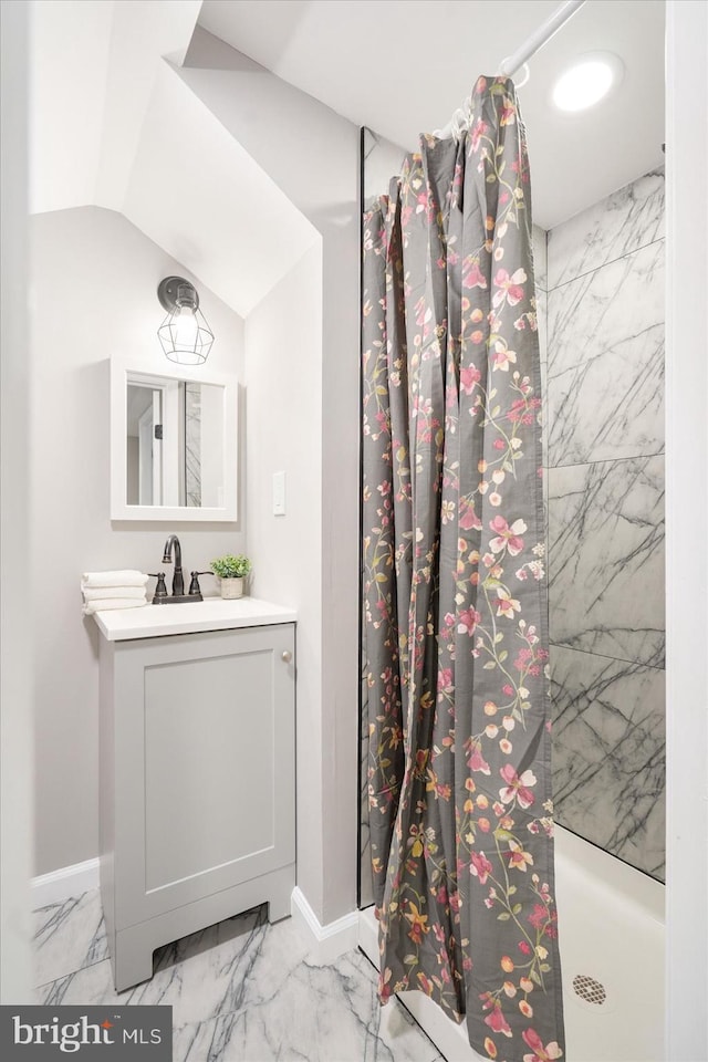 bathroom with vanity, lofted ceiling, and walk in shower