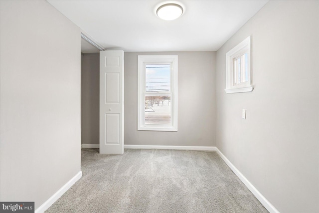 unfurnished room with light carpet