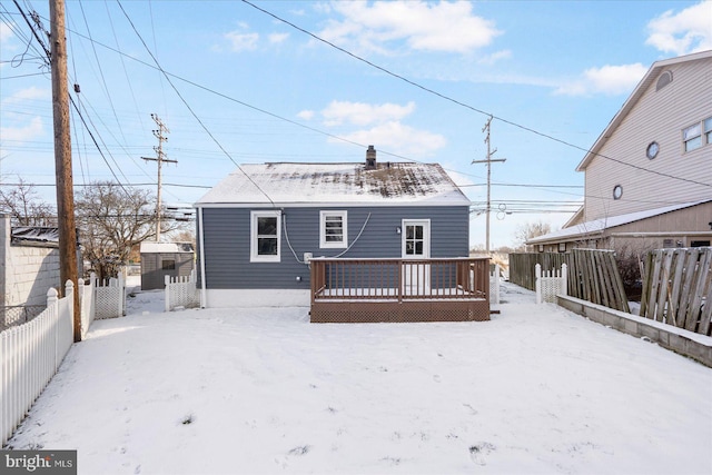 snow covered house featuring a deck