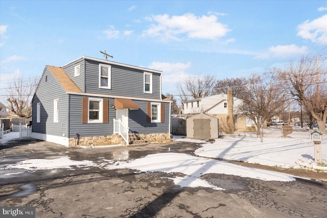 front of property featuring a storage shed