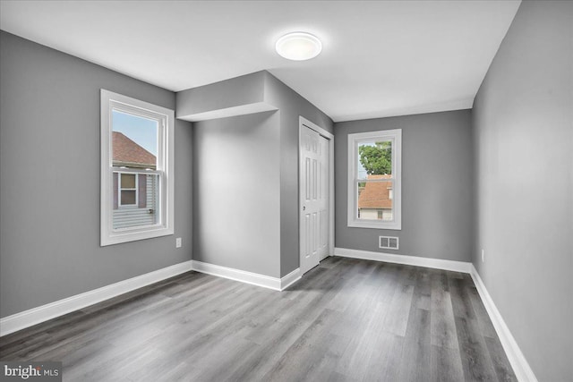 spare room featuring wood-type flooring