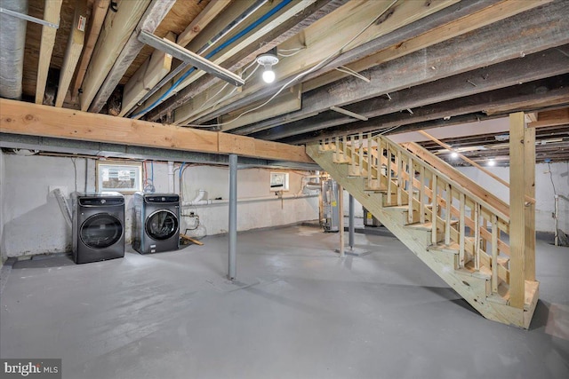 basement with gas water heater and washing machine and clothes dryer