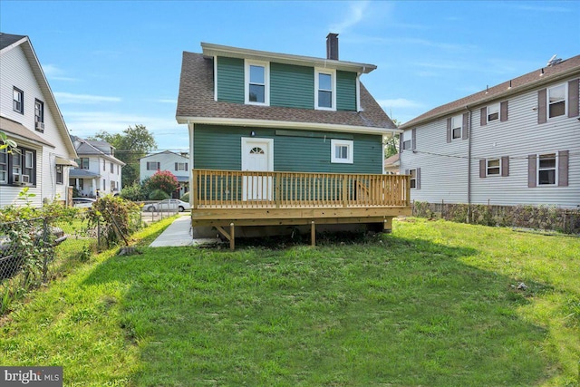 back of house with a lawn and a wooden deck