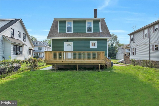 back of house with a wooden deck and a yard