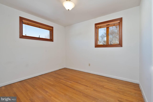 spare room featuring light hardwood / wood-style floors