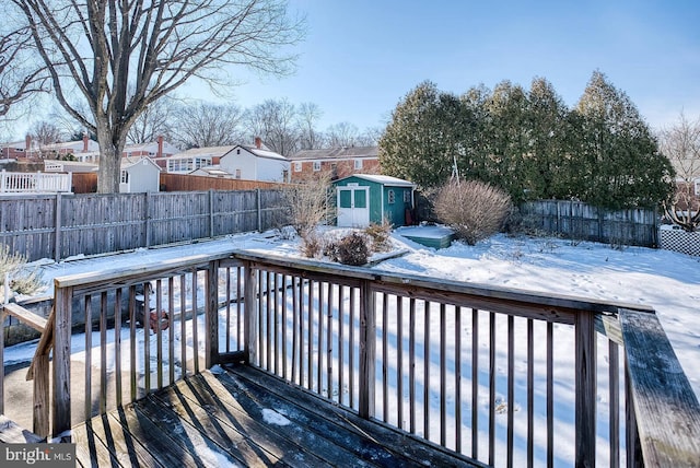 snow covered deck featuring a storage unit