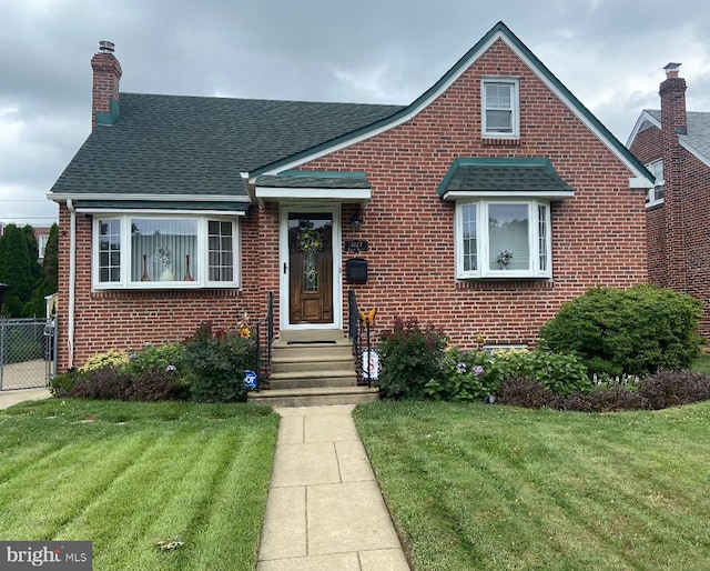 bungalow-style home with a front lawn