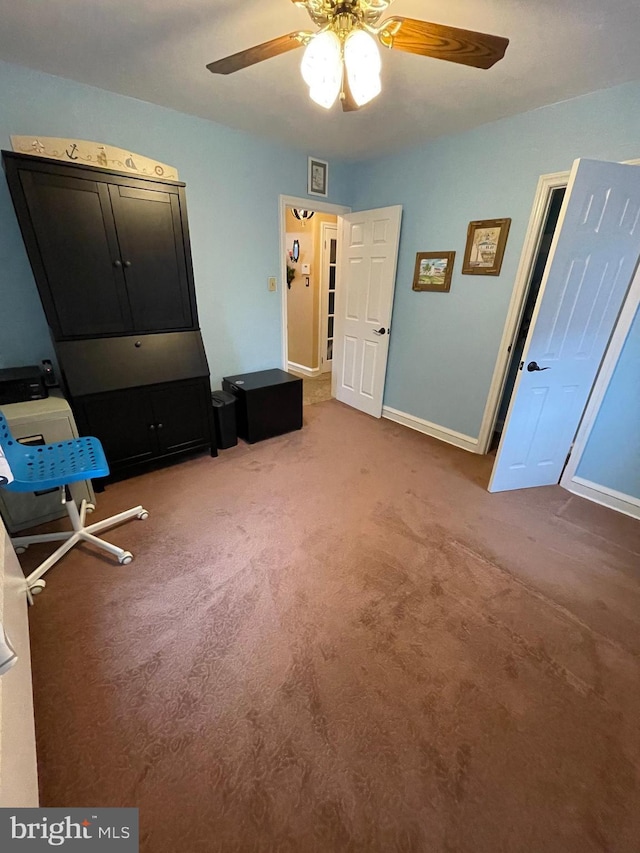 interior space with carpet floors and ceiling fan