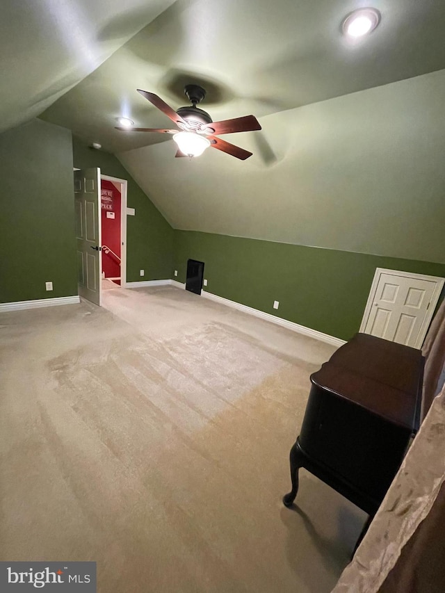 additional living space featuring lofted ceiling, ceiling fan, and carpet