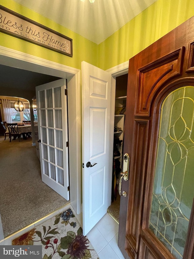 interior space featuring a chandelier and light carpet