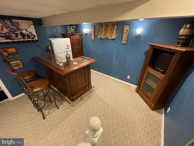 home office featuring bar and carpet flooring