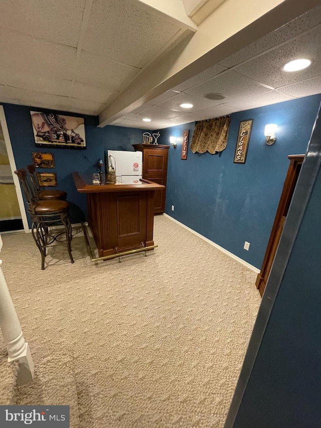 bar featuring fridge and carpet flooring