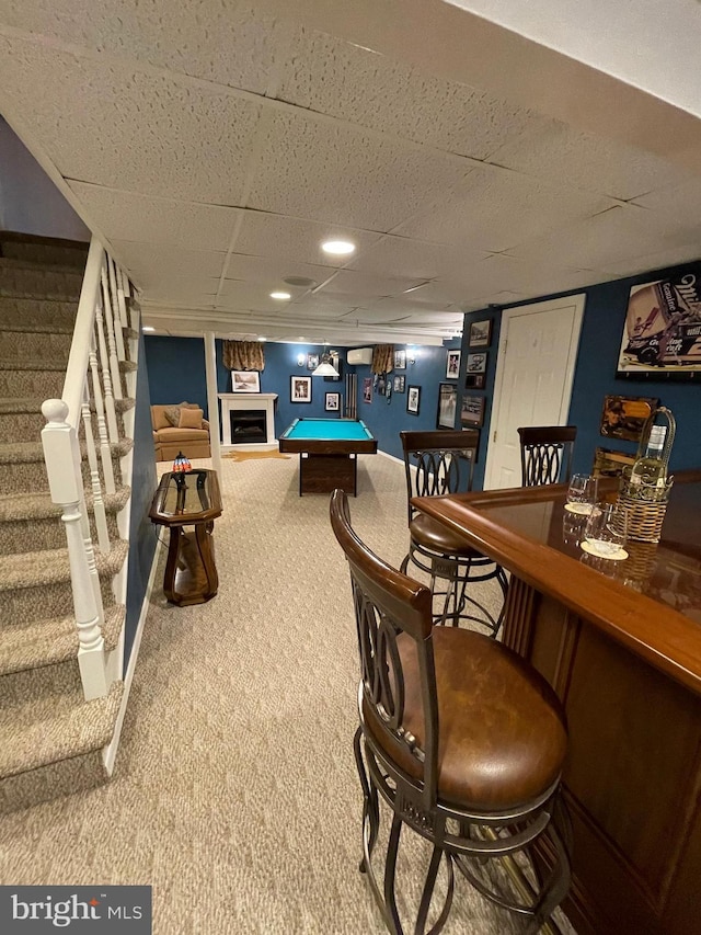 rec room featuring bar, pool table, and carpet