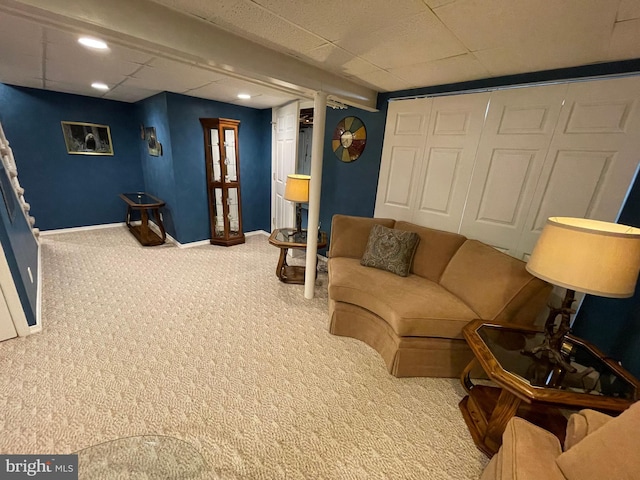 living room with carpet and a drop ceiling