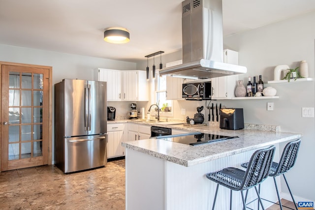 kitchen featuring white cabinets, kitchen peninsula, stainless steel fridge, and island range hood