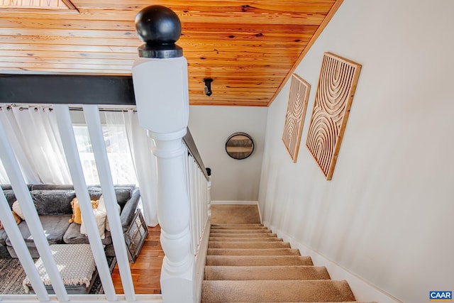 stairway with wood-type flooring and wood ceiling