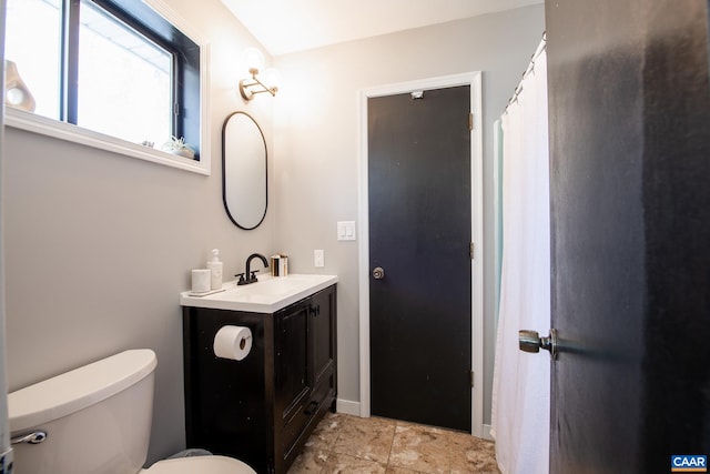 bathroom featuring toilet and vanity