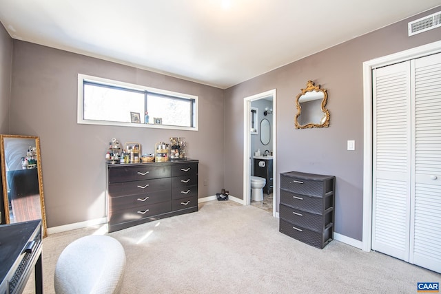 interior space with a closet and ensuite bath