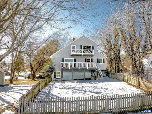 snow covered house with a deck