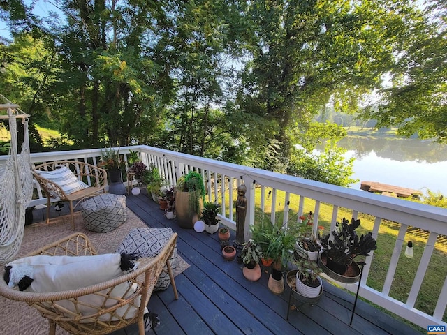 wooden deck with a yard and a water view