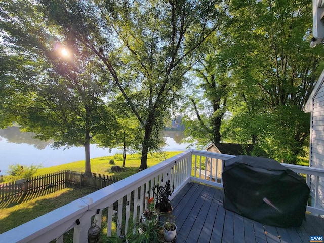 deck with a water view and a grill