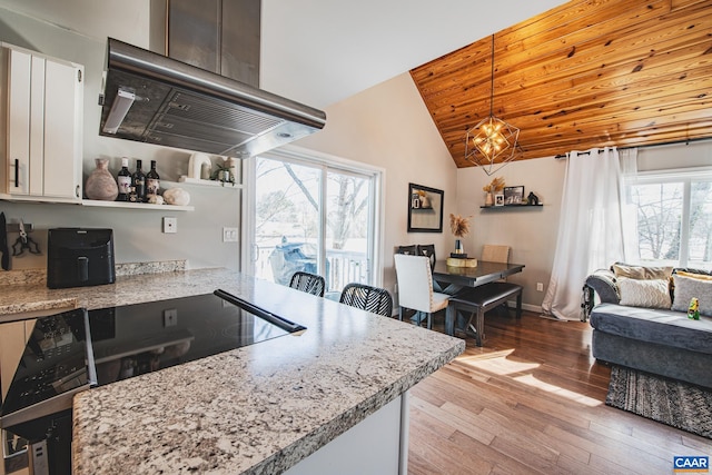 kitchen with light hardwood / wood-style flooring, pendant lighting, white cabinets, wood ceiling, and island range hood