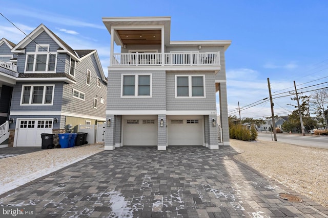 view of front of house featuring a garage and a balcony