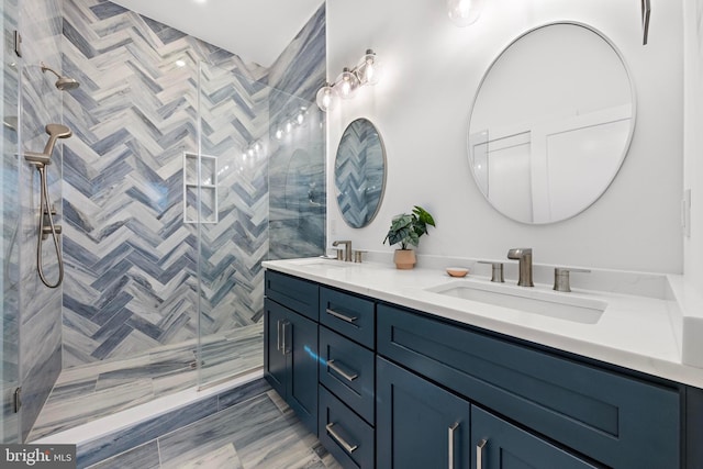 bathroom with vanity and a tile shower