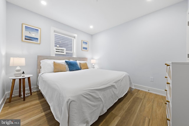 bedroom with wood-type flooring