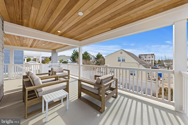 wooden terrace with an outdoor living space