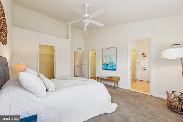 carpeted bedroom featuring a walk in closet, lofted ceiling, and a closet