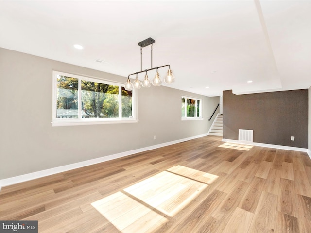 empty room with light hardwood / wood-style flooring