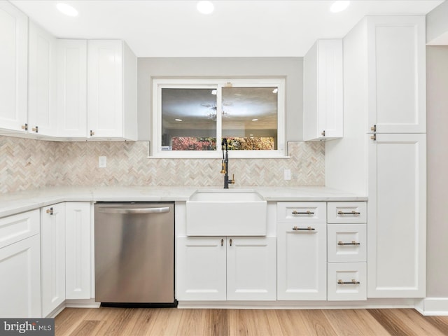 kitchen featuring sink, dishwasher, white cabinetry, and light stone countertops