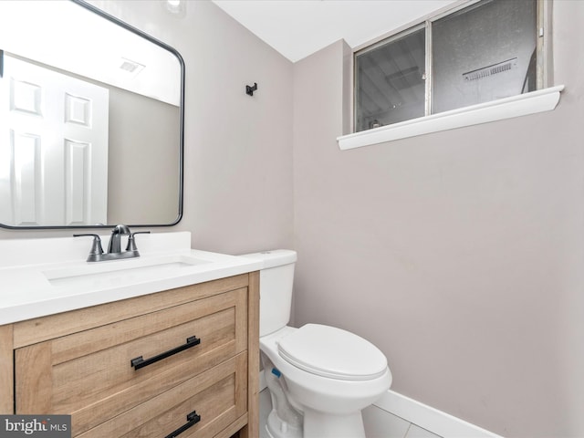 bathroom with tile patterned floors, vanity, and toilet