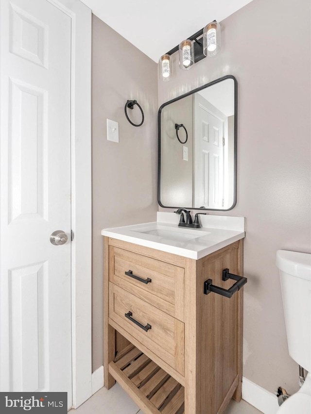 bathroom with toilet and vanity