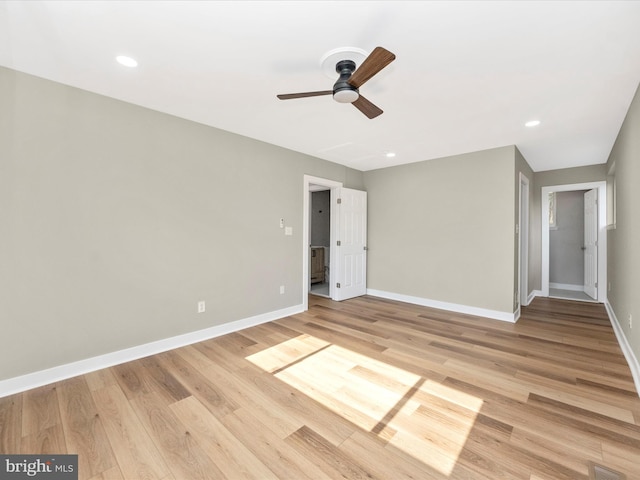 unfurnished bedroom with ceiling fan and light wood-type flooring