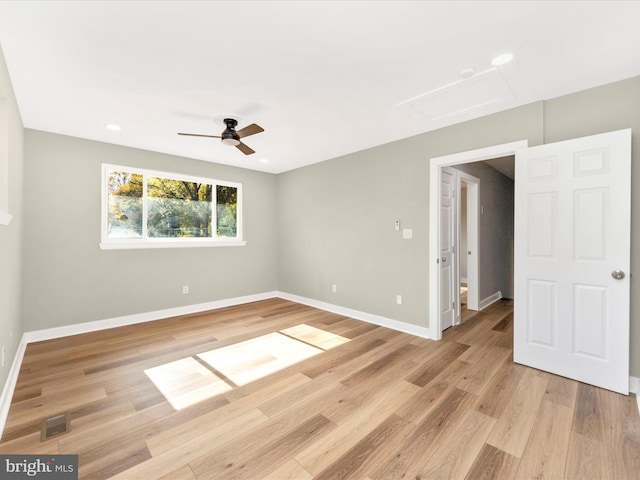 spare room with ceiling fan and light hardwood / wood-style floors