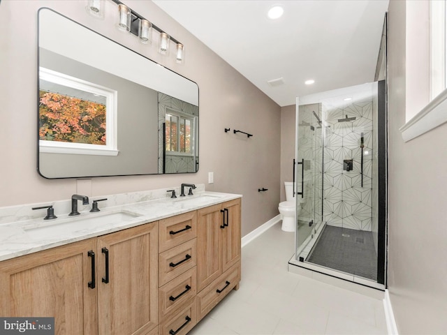 bathroom with toilet, vanity, an enclosed shower, and tile patterned flooring