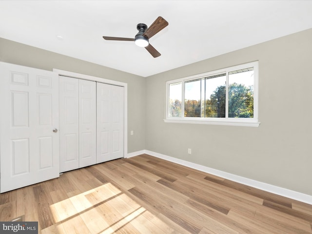 unfurnished bedroom featuring light wood-type flooring, a closet, and ceiling fan