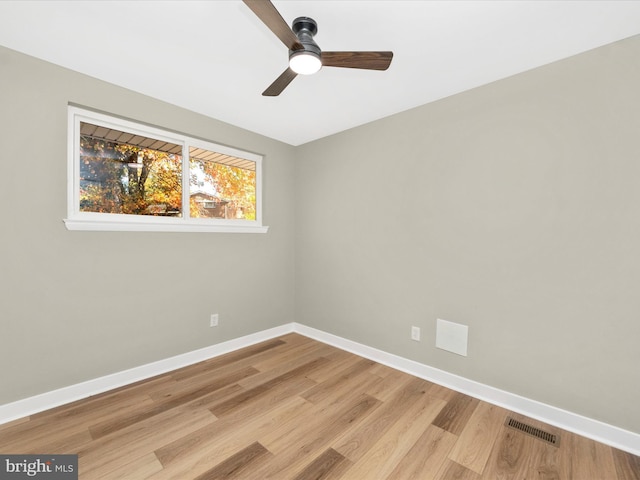 spare room featuring light hardwood / wood-style flooring and ceiling fan