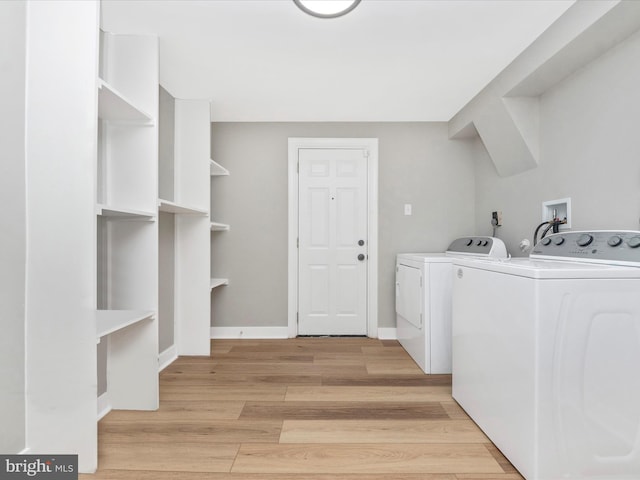 washroom featuring light hardwood / wood-style flooring and washing machine and dryer